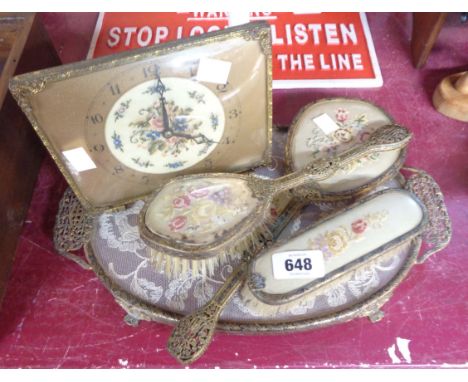 A vintage brass bound glazed embroidered dressing table set with matching clock