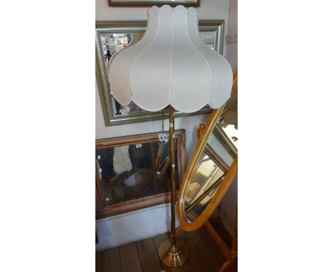 A modern brass standard lamp with shade