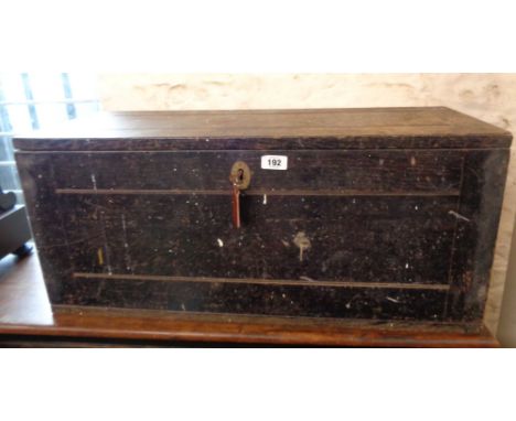 An old black painted wood lift-top toolbox with iron drop handles - sold with a woodgrain effect metal folding worktable