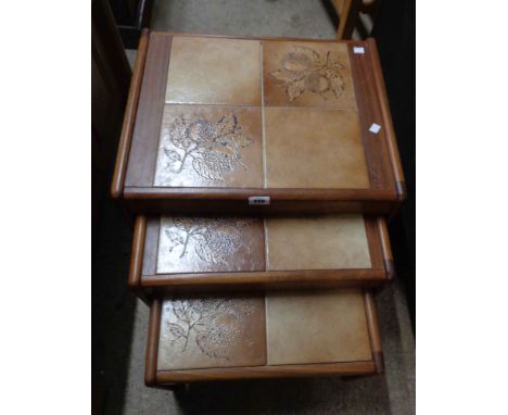 A retro nest of three tile topped tea tables, set on moulded teak supports - bearing label for 'Sunelm Products'