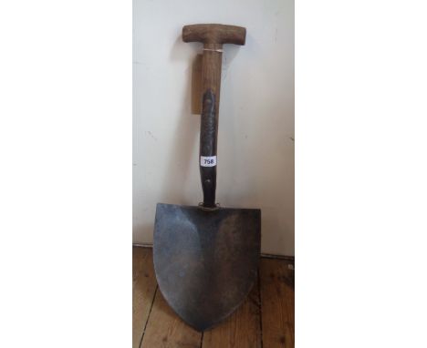 A vintage military trench shovel with WD arrow mark dated 1952