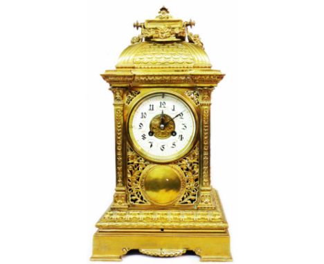 A late 19th Century ornate brass cased bracket clock with pierced all round decoration, crack to dial and Mougin eight day go