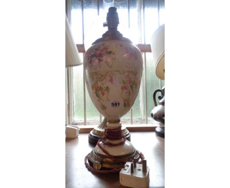 An early 20th Century porcelain table lamp with floral decoration and brass fittings