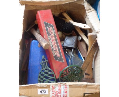 A box containing various vintage tools and other metalware