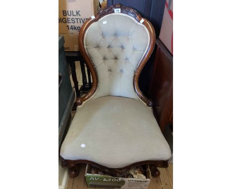 A Victorian carved walnut part show frame spoon back drawing room chair with button back pale green velour upholstery, set on