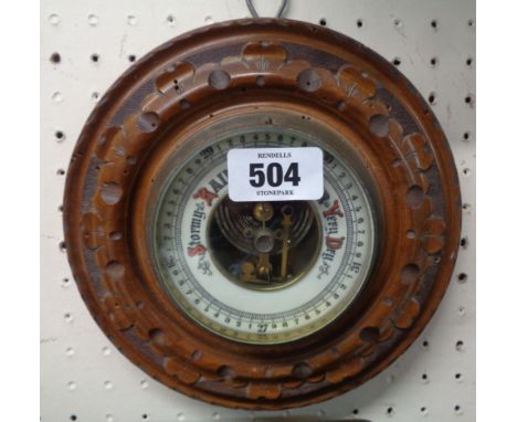 A vintage walnut framed barometer with visible aneroid works to dial centre - old worm damage