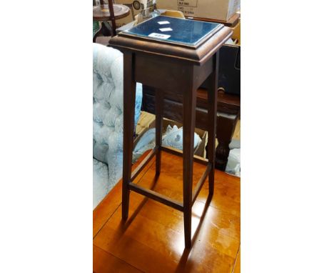 A vintage stained wood jardiniere stand with tile inset top