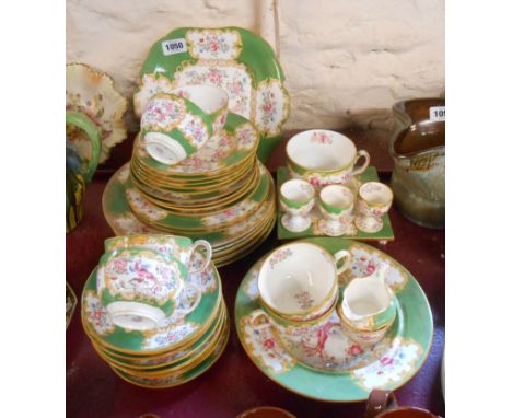 A quantity of Mintons and other tea and dinner ware decorated with an exotic bird on an apple green scale panel ground includ