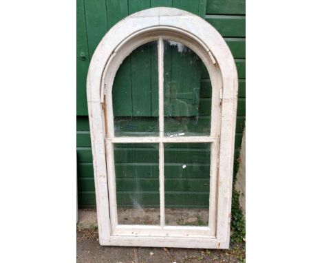 A vintage wooden framed arched sash window