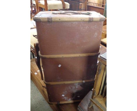 A vintage cane bound travelling trunk with flanking leather handles and weathercoat finish