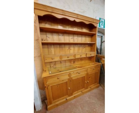 A 1.6m modern pine two part dresser with three shelf open plate rack and four spice drawers over a base with three frieze dra