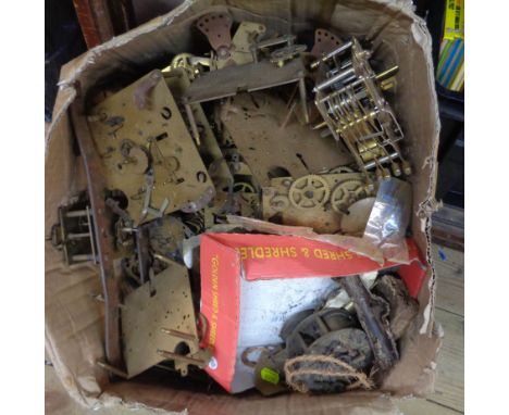 A box containing a quantity of part mantel and other clock movement parts