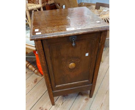 An early 20th Century oak coal purdonium with central boss to fall front, internal liner and shovel - sold with a vintage oak