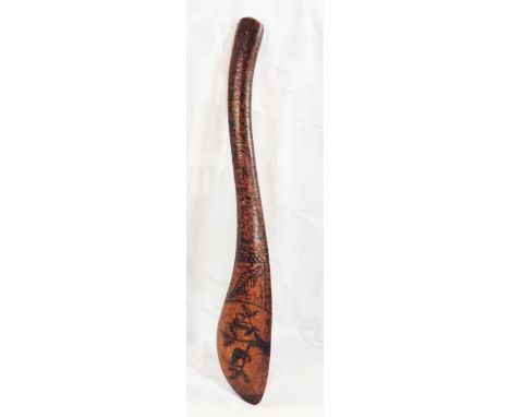 An old Australian Aboriginal wooden club with carved decoration depicting Emus, Kangaroos, and other creatures