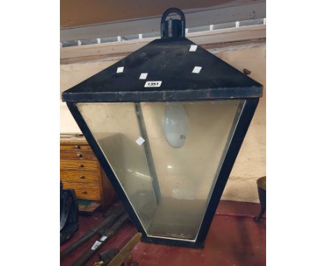A large outdoor glazed street style lamp