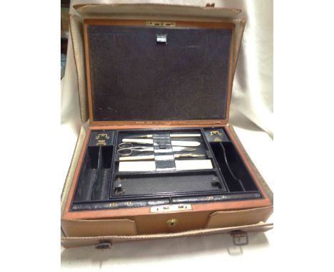 A 19th Century Asprey writing box with fitted interior including dip pens, letter opener, scissors, inkwell, match holder, ac