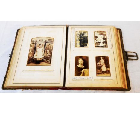 A late Victorian cabinet album containing a collection of posed monochrome portrait photographs, some with photographer's det