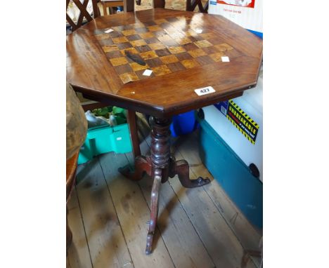 An antique mahogany chess table with octagonal top, set on turned pillar and tripod base - wear