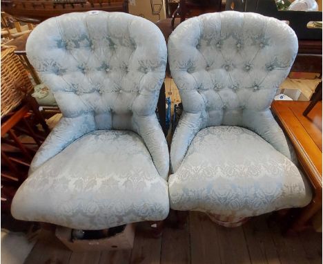A pair of modern spoon back chairs with button back machine tapestry upholstery, set on turned front legs