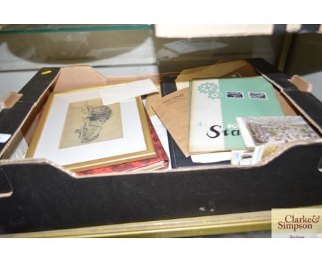 A box containing miscellaneous post-cards, stamps, print of a lion etc. 