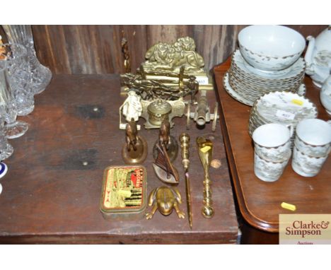 A pair of brass lion mantel ornaments; a brass inkwell etc.