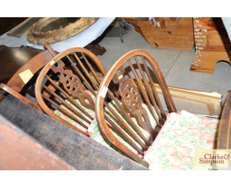 A pair of stick and wheelback elm seated dining chairs; and a bar back chair 
