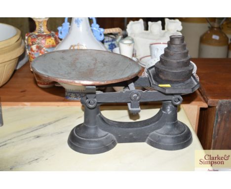 A set of cast iron kitchen scales and weights 
