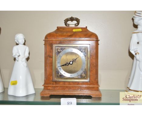 A walnut cased mantel clock by Elliott 