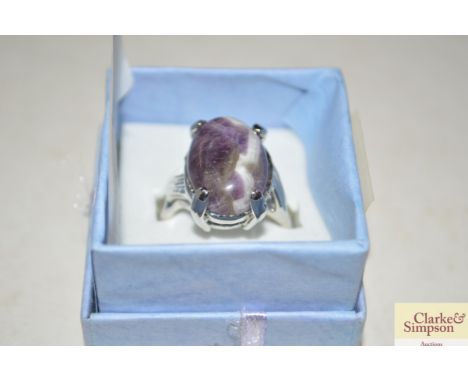 A white metal ring set with amethyst stone 