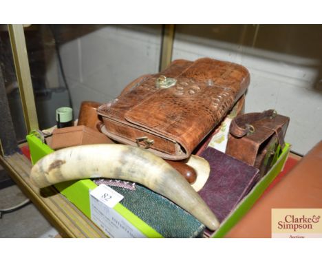 A box containing various items including a turned wooden gavel; a horn; an alligator skin type handbag; various ephemera etc.