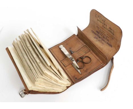 A Leather Fly Wallet by Joseph Smyth of Darlington containing some tools and a selection of flies.