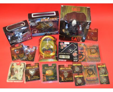 Good mixed lot of film related toys/memorabilia - SAW, Star Trek, Pirates Of The Caribbean and Lord Of The Rings. (18)