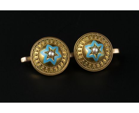 AN ENAMEL AND HALF PEARL BAR BROOCH, designed as two circular bosses, each centred with a blue enamel and half pearl star mot