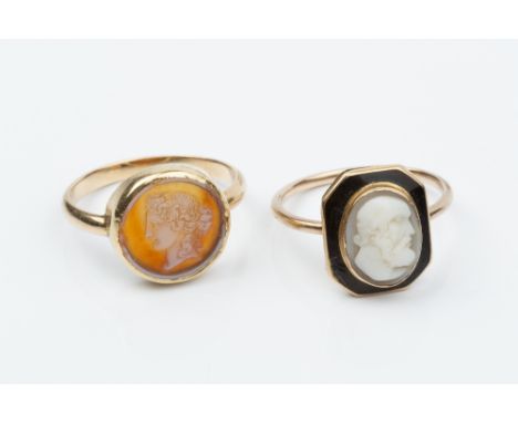 TWO CAMEO RINGS, the first centred with an oval shell cameo, carved to depict a classical male portrait profile, to an octago