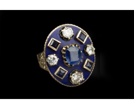 A SAPPHIRE, DIAMOND AND ENAMEL PANEL RING, the oval blue enamel panel centred with a cushion-shaped mixed-cut sapphire, borde