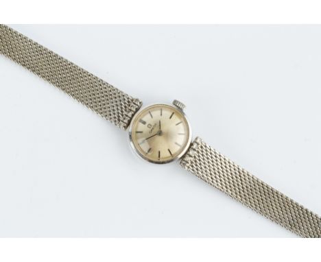 A LADY'S DIAMOND SET BRACELET WATCH BY OMEGA, the circular silvered dial with baton markers, to a jewelled manual movement, o