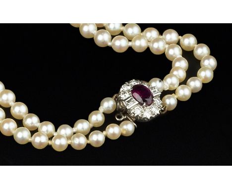 A CULTURED PEARL NECKLACE WITH RUBY AND DIAMOND CLASP, comprising two strands of graduated cultured pearls, to a cluster pane