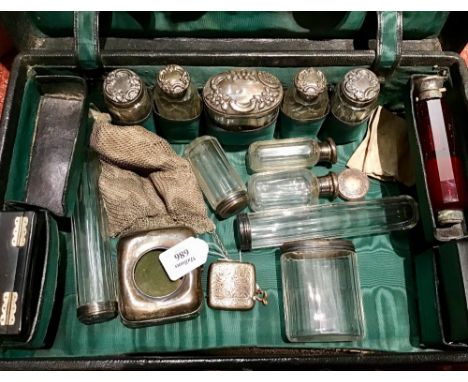 AN EDWARDIAN DRESSING CASE, the fitted interior containing six silver topped faceted glass jars, Birmingham 1903; and various