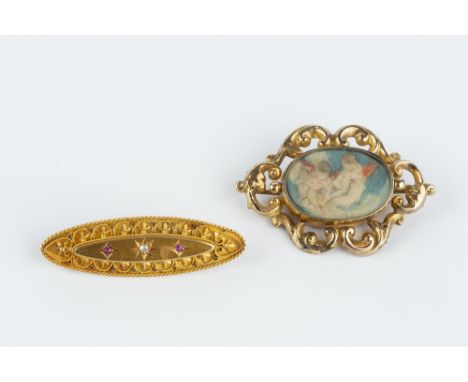 A LATE VICTORIAN RUBY AND DIAMOND SET PANEL BROOCH, the navette-shaped panel applied with ropetwist wirework, foliage and bea