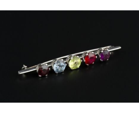 A VARI GEM-SET BAR BROOCH, the knife edge bar spaced with five circular mixed-cut stones, to include amethyst, garnet, synthe