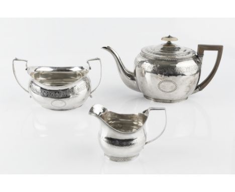 A GEORGE III SILVER TEAPOT, of oval form, engraved with Greek key and anthemion frieze, having fruitwood handle and ivory kno