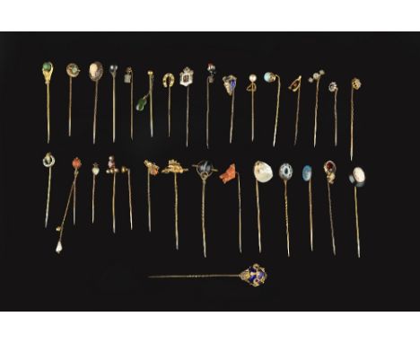 A COLLECTION OF STICK PINS, to include a coral corallium rubrum stick pin, carved to depict a boar's head clasping a creature