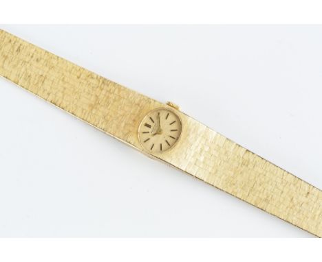 A LADY'S 18CT GOLD BRACELET WATCH BY INTERNATIONAL WATCH COMPANY, the oval gilt dial with black baton markers, to a jewelled 