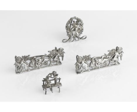 A PAIR OF LATE VICTORIAN SILVER MENU HOLDERS, each pierced and embossed with cherubs and fruiting vine, by Mappin &amp; Webb,