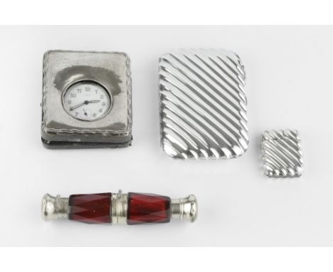 A 19TH CENTURY RUBY GLASS DOUBLE ENDED SCENT BOTTLE, with faceted, slightly tapered hinged body, and gilt mounts, 13.5cm, in 