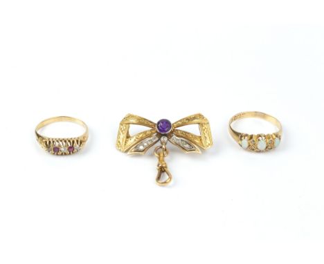 AN AMETHYST AND DIAMOND SET BOW BROOCH, the foliate engraved ribbon bow centred with a circular mixed-cut amethyst and channe