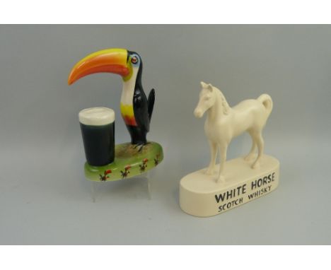 A Carlton Ware Guinness advertising table lamp base, as a Toucan and full pint glass, on an oval green base, transfer printed