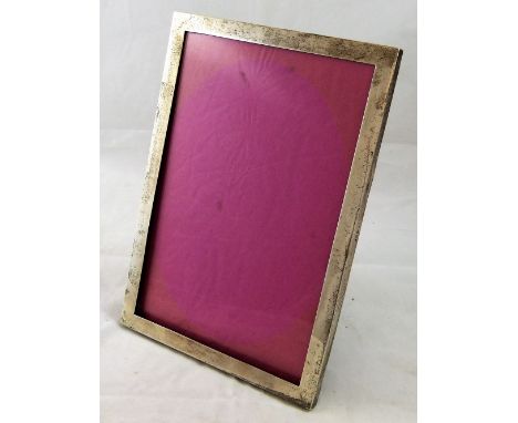 An Edwardian silver photograph frame, London 1903, of plain rectangular form with wooden easel back, 26 x 18.5 cm.