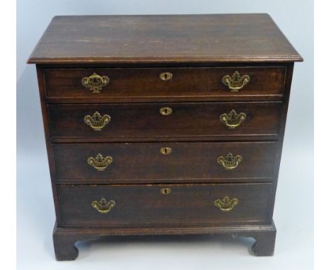 A George III oak chest of four long graduated cock beaded drawers, with pierced brass swan neck handles and bracket feet, 86 