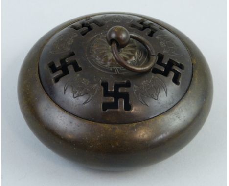 A Chinese bronze censor of flattened circular form, the lift off cover with pierced religious runes and engraved bats, cast s